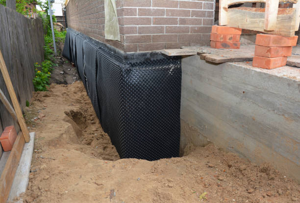 SJ Waterproofing Pros technician performing targeted Exterior Waterproofing assessment in Newport, NJ